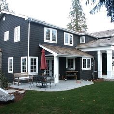 a black house with white trim and windows