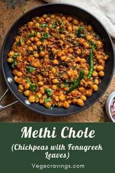 a skillet filled with chickpeas and fennels on top of a table