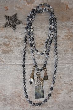 Seemingly endless Spider vein jasper is hand knotted with silk, from which hangs an Ethiopian cross pendant with additional crystal and labradorite charms. This versatile layering piece can be worn long, wrapped once or twice, or worn lariat style.