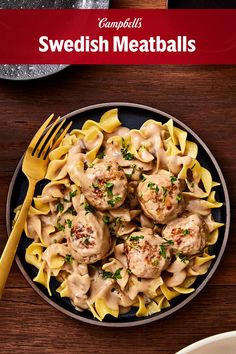 a plate full of pasta with meatballs and sauce on the side next to a fork