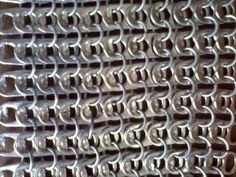 a close up view of a metal grate with circles and lines on the surface