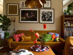 a living room filled with furniture and pictures on the wall