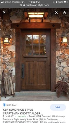 a wooden front door with two lights on each side and a window above it that is lit up