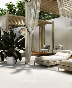 a living room with white furniture and plants