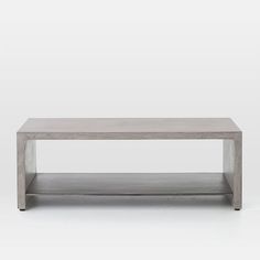 a gray coffee table with two shelves on each side and one shelf below it, against a white background