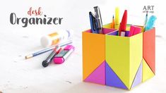 an origami pencil holder with pens and markers