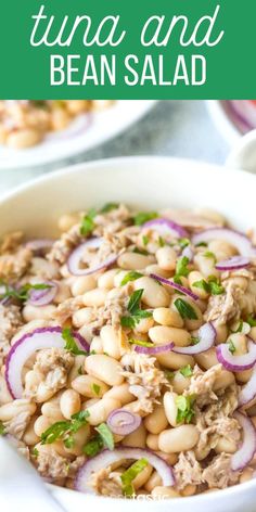 tuna and bean salad in a white bowl with red onions, cilantro and parsley