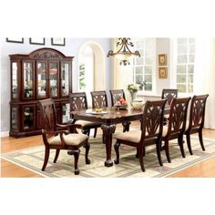 a dining room table with chairs and china cabinet