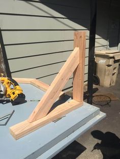 a piece of wood sitting on top of a table next to a power drill and saw