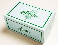 a white box with green writing on the top and bottom that says sanibello's