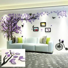 the living room is decorated with purple flowers and butterflies on the wall, along with a white couch