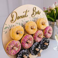 there are many donuts that are on the table and one is decorated with sprinkles