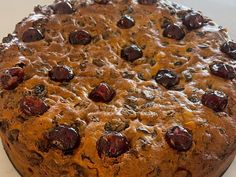 a cake with cherries on it sitting on a plate