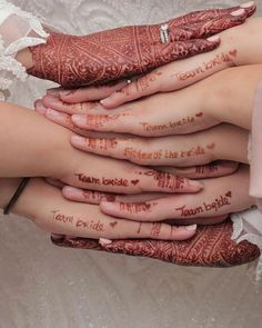 the brides hands are covered with hennap and words that spell out their names