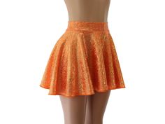 "This skirt features a sparkly gold and neon orange hologram spandex.   SKIRT LENGTHS Length of skirts vary by size below.   Please submit a custom request for lengths not shown.   FRONT/BACK Toddler 2/37\"/8\" Child X-Small        10\" /       11\" Child Small11\"/12\" Child 6X-711\"/12\" Child Medium13\"/14\" Child Large13\"/14\" Adult XS        13\"/14\" Adult Small        15\"     /   16\" Adult Medium15\" /16\" Adult Large16\"/17\" Adult X-Large17\"/18\" Adult 2X        17\"     /   18\" Ad Shiny Stretch Mini Skirt Bottoms, Shiny Stretch Mini Skirt, Fitted Gold Flared Skirt, Gold Fitted Flared Skirt, Fitted Orange Skirt, Fitted Gold Mini Skirt With Lining, Fitted Orange Skort, Fitted Orange Mini Skirt, Orange Fitted Mini Skirt