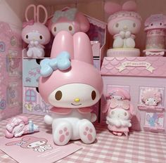 the hello kitty doll house is pink and has many accessories on it's shelves