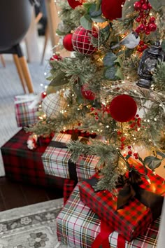 a decorated christmas tree with presents under it