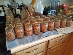 there are many jars with food in them on the counter