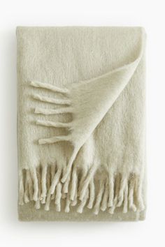 a white blanket with fringes on it