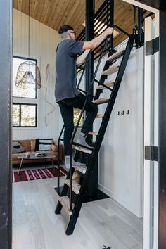 a man is climbing the stairs in his house