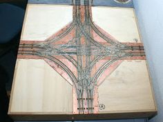 a cross made out of wood sitting on top of a table