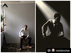 a man sitting on top of a stool in front of a light and a camera