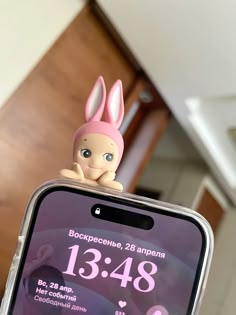 a person holding up a cell phone with an easter bunny on it