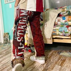 a man standing on top of a wooden floor next to a bed