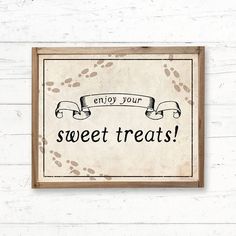 a framed sign that says enjoy your sweet treats on the side of a white wall