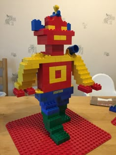 a lego man standing on top of a red rug