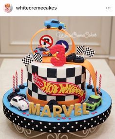 a birthday cake decorated with cars and candles