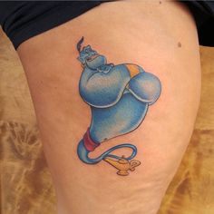 a cartoon character tattoo on the thigh