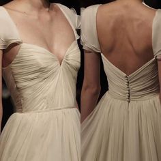 the back of two women's gowns on display at a fashion show,