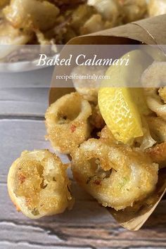 baked calamari with lemon wedges and garlic on the side, in a paper bag