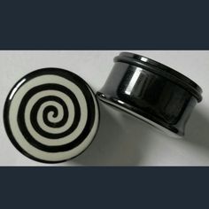 a black and white container sitting on top of a table next to a metal object