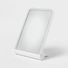 an illuminated mirror is shown on a white surface