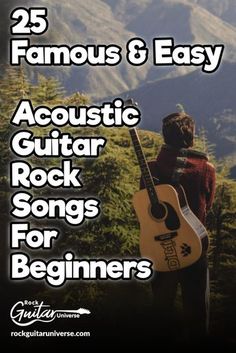 a man standing on top of a mountain holding a guitar and looking at the mountains