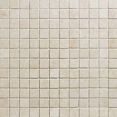 a white tiled wall with small squares on it