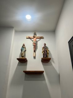 three wooden crucifixs mounted on the wall