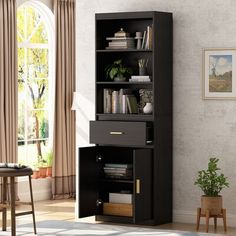 a black bookcase in a living room next to a window