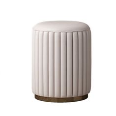 a white stool sitting on top of a wooden table