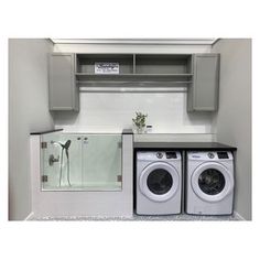 a washer and dryer sitting in front of a shelf above the washer