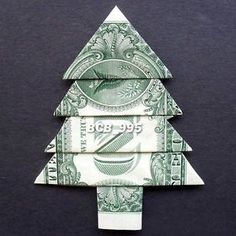 an origami christmas tree made out of one dollar bill on a black background