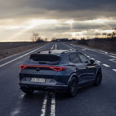 the rear end of a car driving down an empty road