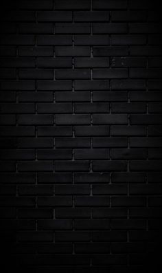 a black brick wall that is very dark