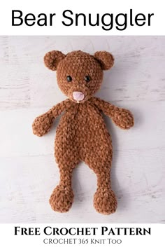 a crocheted brown teddy bear sitting on top of a white wooden floor with its tongue sticking out