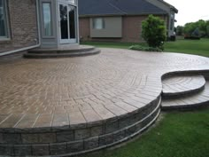 a brick patio with steps leading up to it