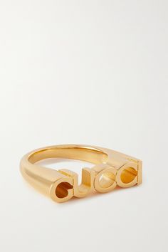 This ring is an easy way to show your love for all things Gucci. Made from gold-tone metal, it's cast in the shape of the label's logo and has a chunky shape. Luxury Gold-tone Jewelry With Logo, Luxury Gold-tone Logo Jewelry, Designer Gold Jewelry With Logo, Luxury Gold-tone Jewelry With Logo Lettering, Designer Gold Jewelry With Metal Logo, Designer Yellow Gold Jewelry With Logo Lettering, Modern Metal Jewelry With Logo, Classic Gold Jewelry With Logo, Classic Yellow Gold Jewelry With Logo