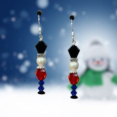 a pair of earrings with red, white and blue beads hanging from it's hooks