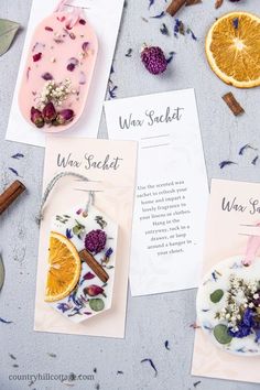 three cards with dried fruit and herbs on them next to cinnamons, an orange slice